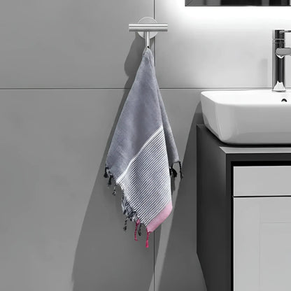 Gray and pink striped turkish cotton towel with tassels hanging from silver hook ruby striped turkish style