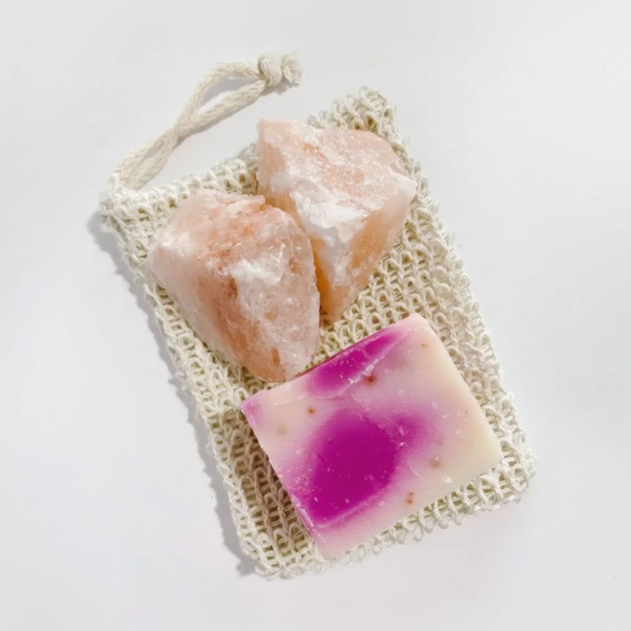 Pink passion fruit soap bar in woven bag with salt crystals for body scrub