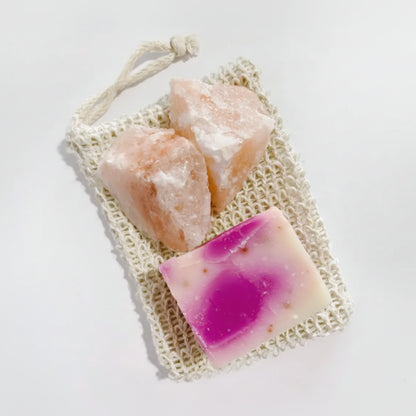 Pink passion fruit soap bar in woven bag with salt crystals for body scrub