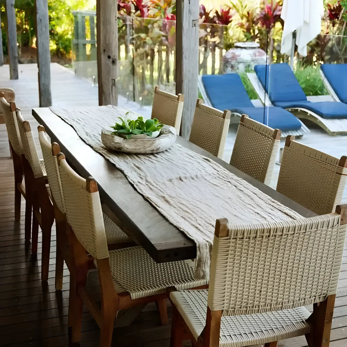 Long wooden dining table with chunky linen table runner and succulent centerpiece
