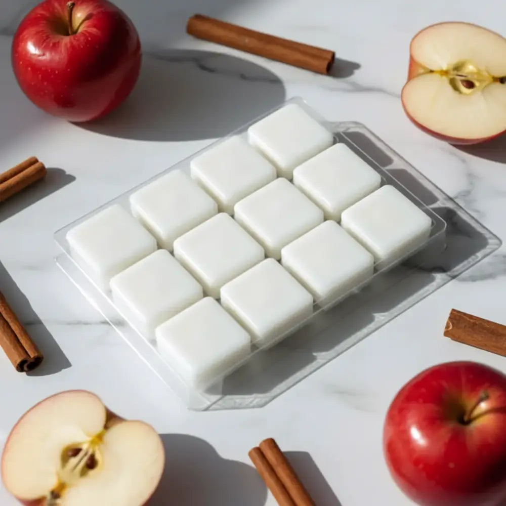 White square cinnamon spiced apples coconut-soy wax melts neatly arranged in a clear plastic tray