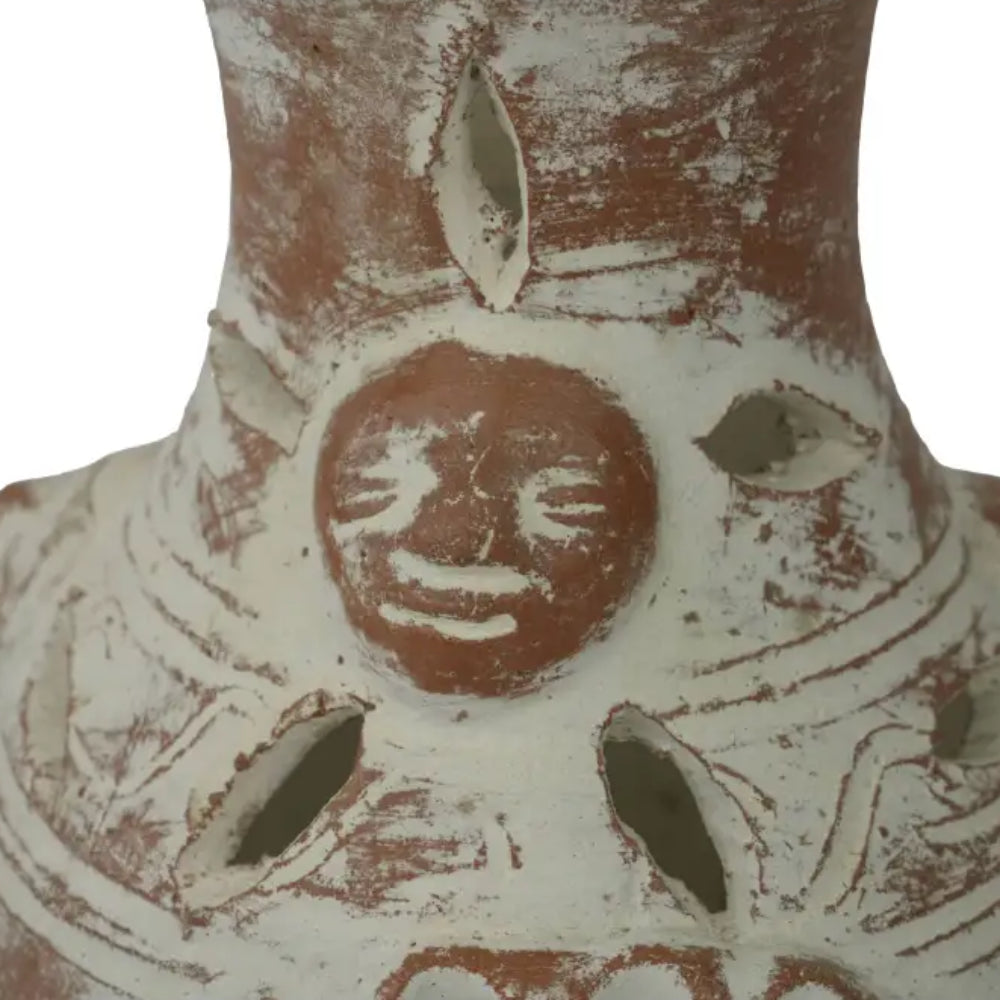 Hand-painted terracotta candle holder with red face and green leaves design