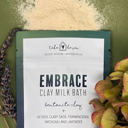 A white pouch of take havens embrace clay milk bath with clary sage for calmness featuring minimalist black text and heart logo