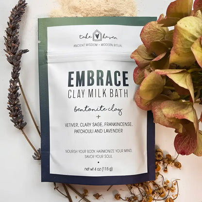 A white and navy pouch of take haven embrace clay milk bath with clary sage and bentonite clay for calmness