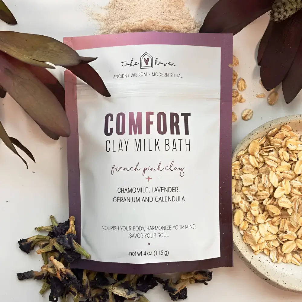 A purple and white pouch of take haven clay milk bath soak with french pink clay and calming botanicals for comfort