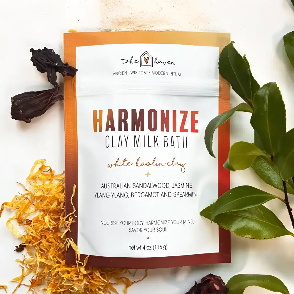Take haven harmonize clay milk bath soak pouch with australian sandalwood and ylang ylang surrounded by colorful leaves