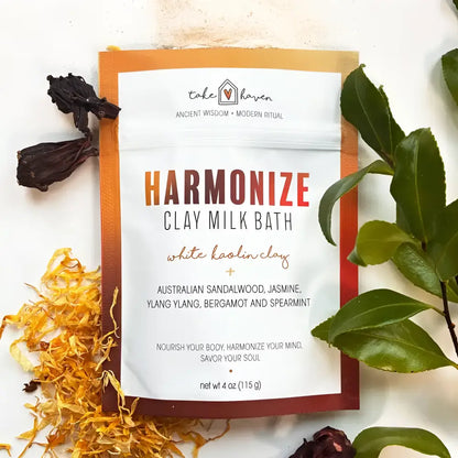Take haven harmonize clay milk bath soak pouch with australian sandalwood and ylang ylang surrounded by colorful leaves