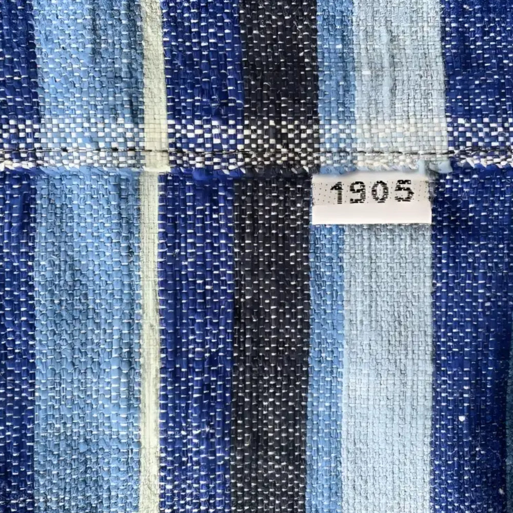 Vintage-style handmade ethiopian table runner with woven fabric in blue green and black stripes highlighting climate warming