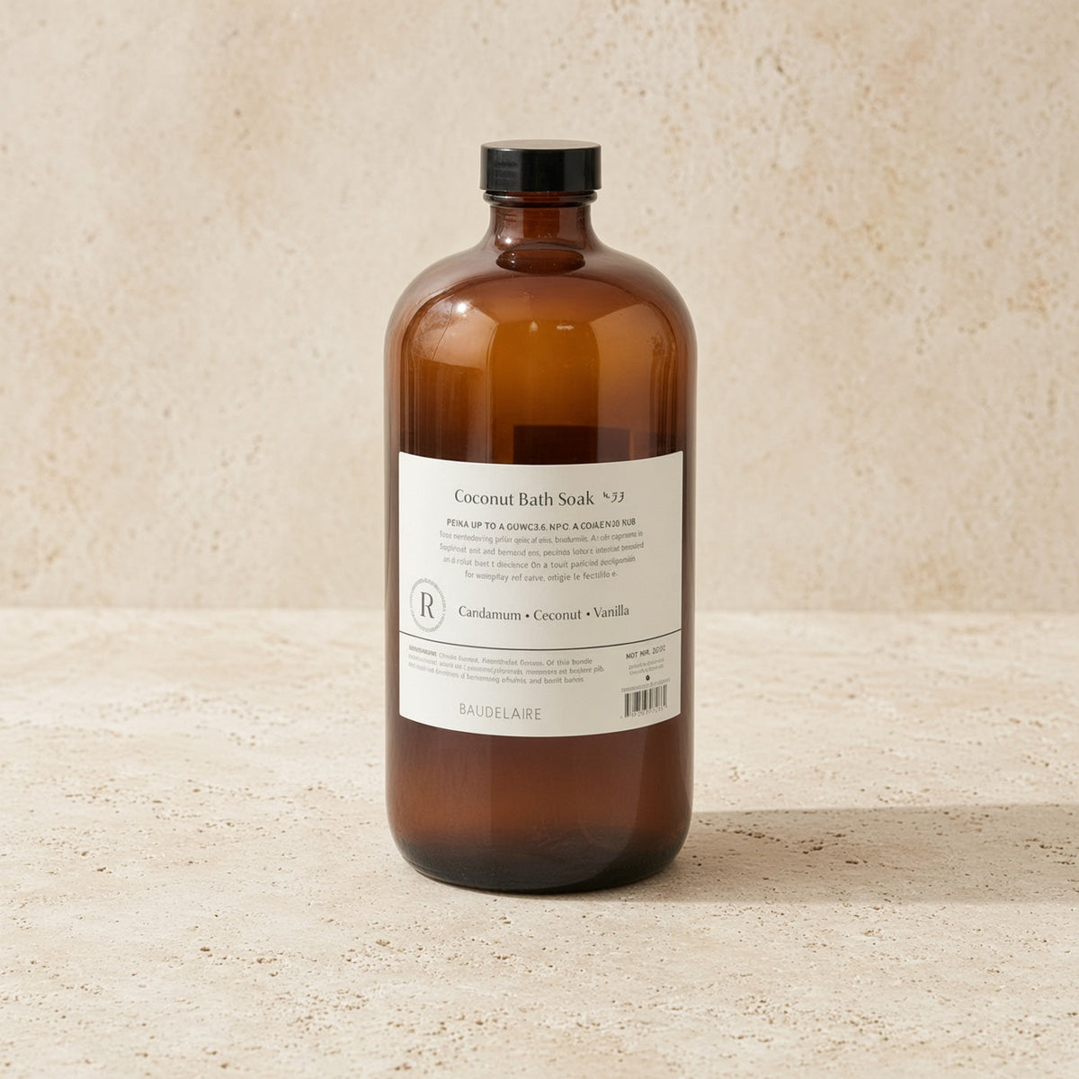 A sleek amber glass bottle with black cap labeled coconut bath soak by baudelaire replenishing 40oz for skin texture
