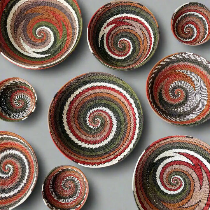 wire bowls with swirling designs in brown, green and orange on a white background