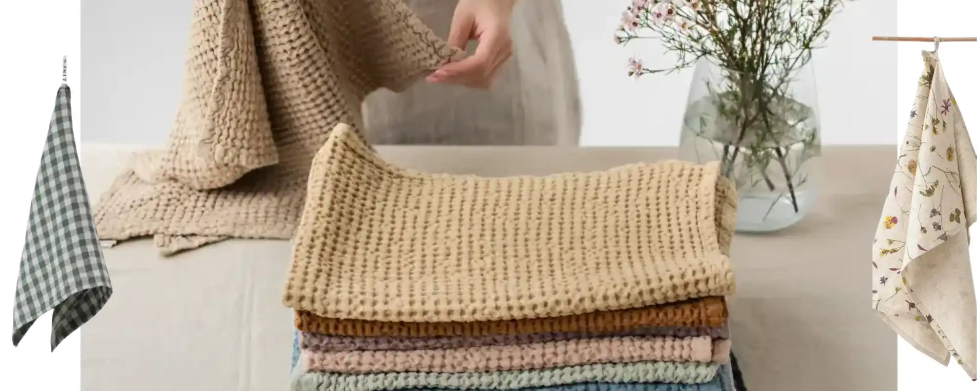 A collection of textured waffle-weave kitchen towels in various colors, including a checkered pattern and a floral design.