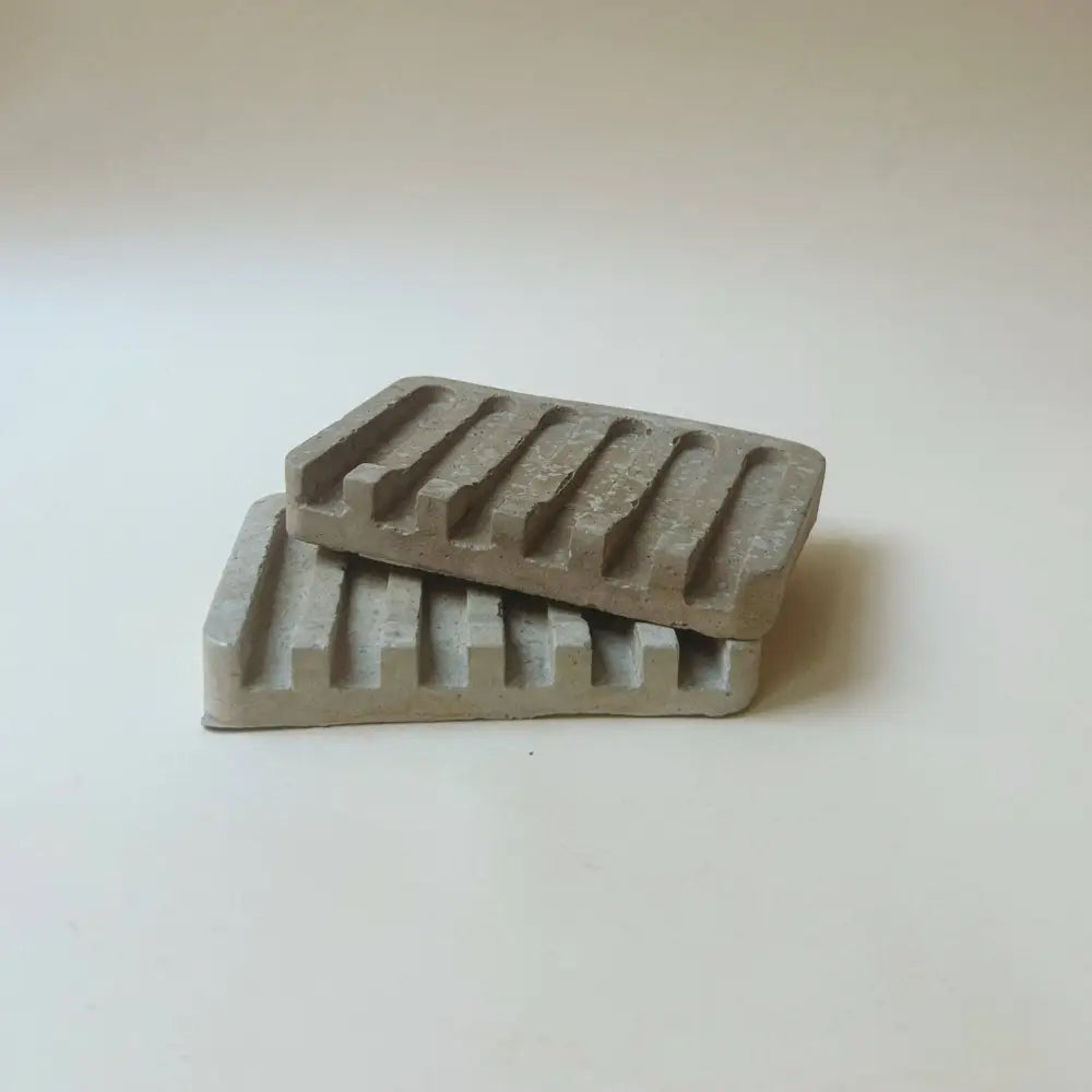 Hand poured concrete and botanical powders soap dishes in brown or gray.