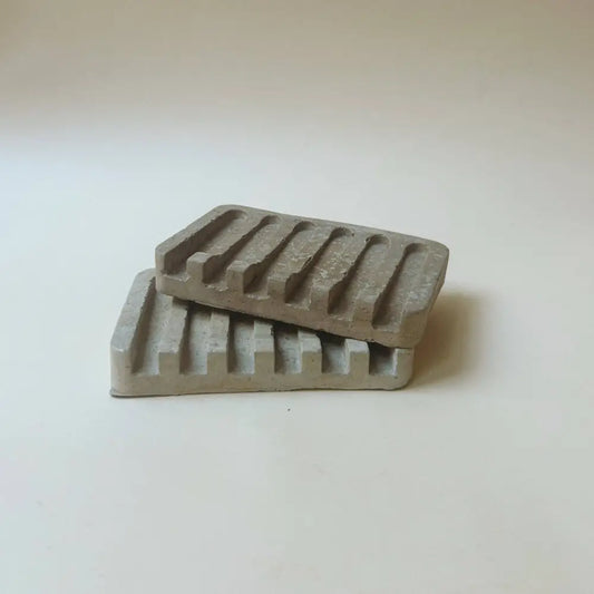 Hand poured concrete and botanical powders soap dishes in brown or gray.
