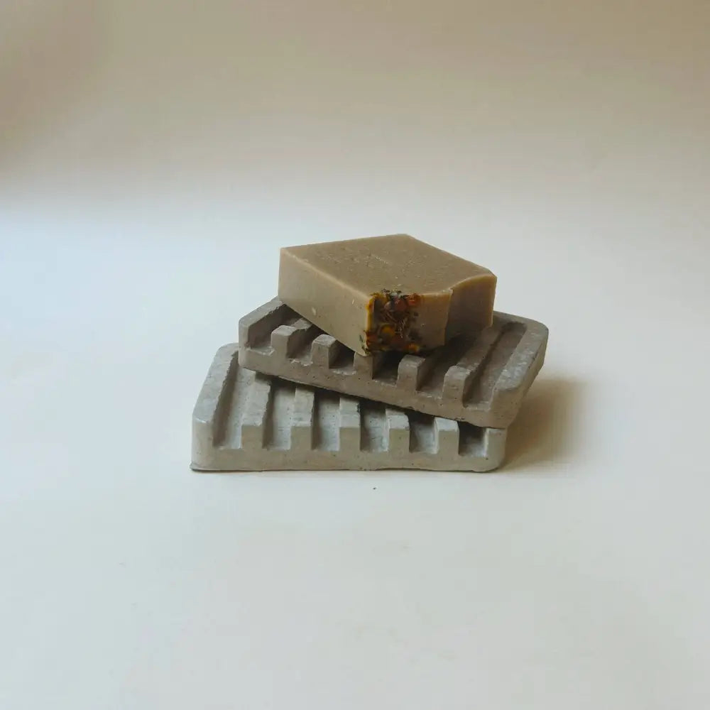 Hand poured concrete and botanical powders soap dishes in brown or gray.