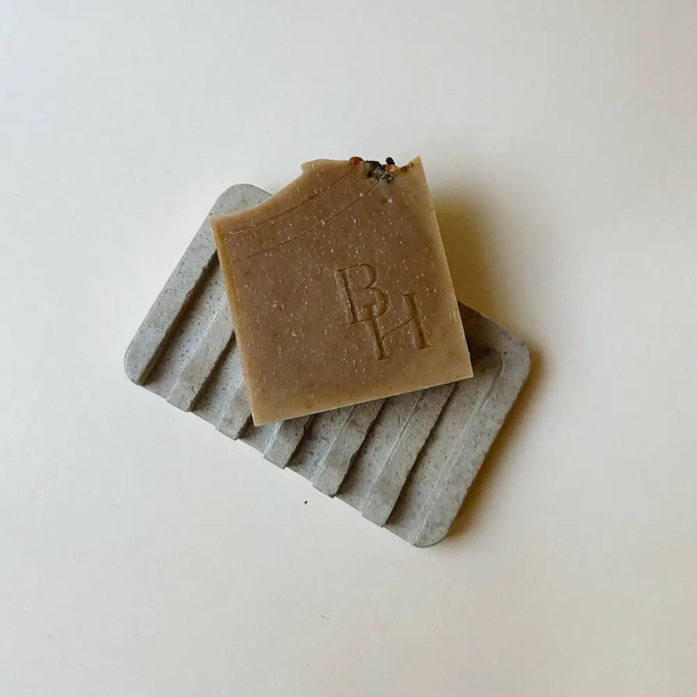 Hand poured concrete and botanical powders soap dishes in brown or gray.