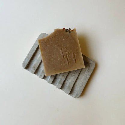 Hand poured concrete and botanical powders soap dishes in brown or gray.