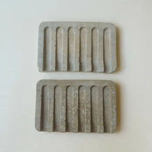 Hand poured concrete and botanical powders soap dishes in brown or gray.