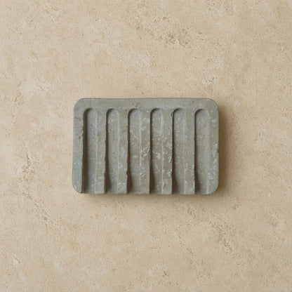 Gray hand poured concrete soap tray with vertical ridges perfect as a durable concrete tray for soap storage