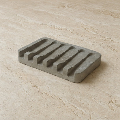 Gray concrete soap tray with five rectangular slots made from hand poured concrete for bathroom use