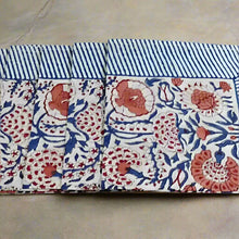 Four folded Green Heron hand block print napkins with blue stripes and coral florals