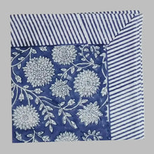 A cotton napkin with traditional Indian block print designs in indigo blue.