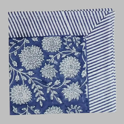 A cotton napkin with traditional Indian block print designs in indigo blue.