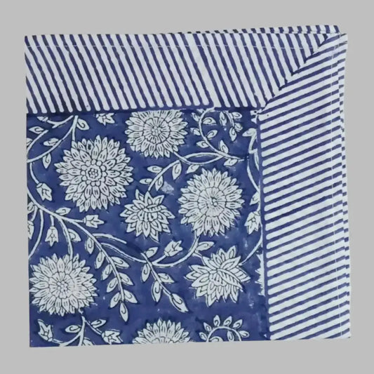 A cotton napkin with traditional Indian block print designs in indigo blue.