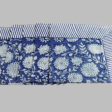 A cotton napkin with traditional Indian block print designs in indigo blue.