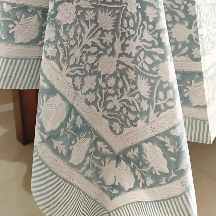Teal and white cotton block print tablecloth with striped borders showcasing block printing techniques