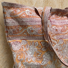 A peach cotton canvas tote bag with rashmi orange pattern and hand block printing featuring floral paisley designs