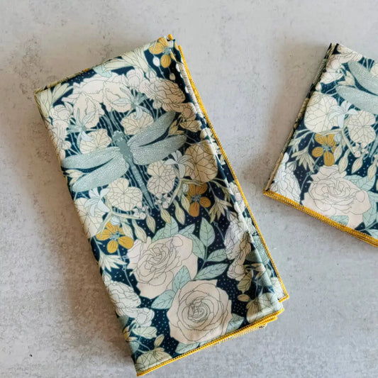 Two floral-patterned napkins on a light gray surface