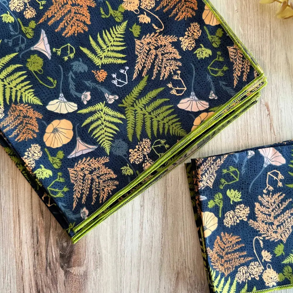 Two patterned napkins on a wooden surface