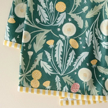 Cotton tea towel with dandelion motif in green soft fabric featuring white and yellow dandelions with striped trim