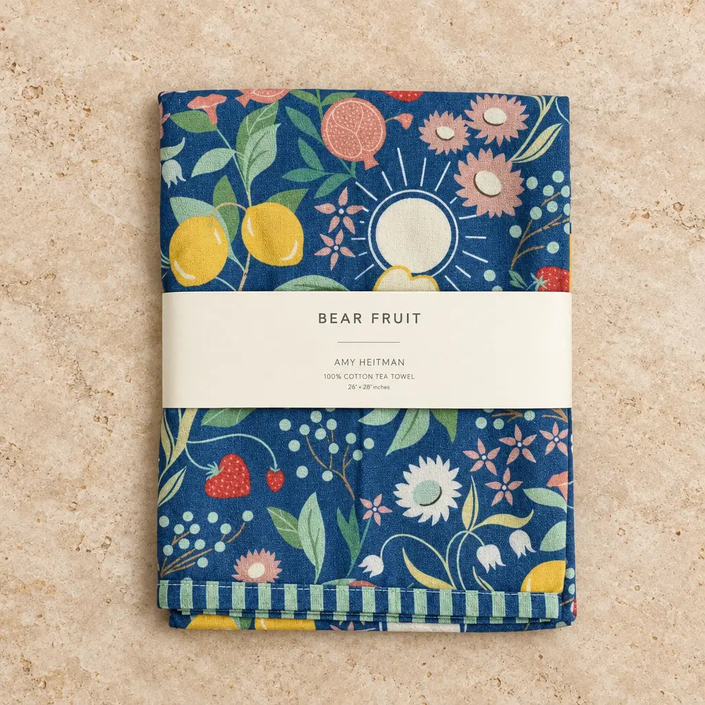 Navy blue cotton tea towel with fruit flowers and a sun motif featuring charming striped edges and vibrant print