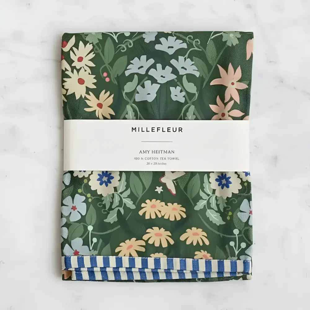 Folded dark green cotton tea towel with vibrant floral pattern and blue white striped border perfect for kitchen use