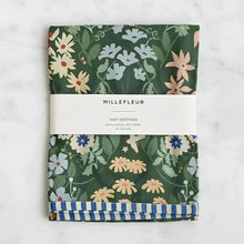Folded dark green cotton tea towel with vibrant floral pattern and blue white striped border perfect for kitchen use