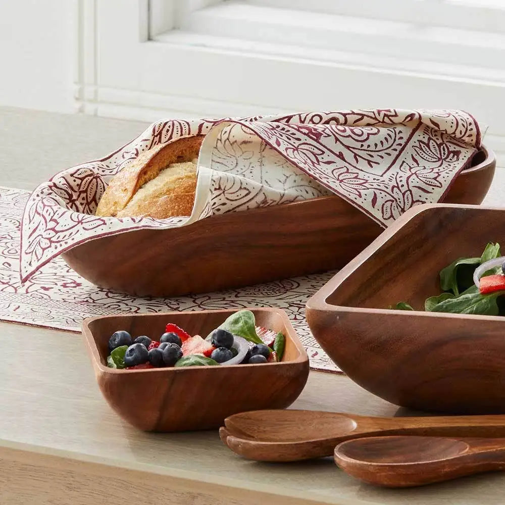 Wooden serving bowls and spoons with cranberry vine block print napkins featuring floral patterns