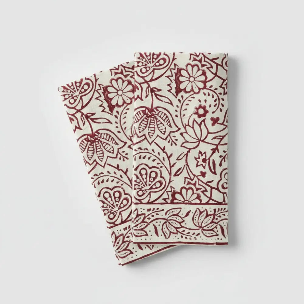 Two off-white Cranberry Vine Block Print Napkins with red floral patterns