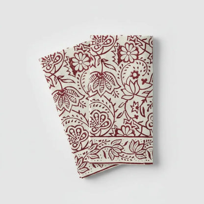 Two off-white Cranberry Vine Block Print Napkins with red floral patterns