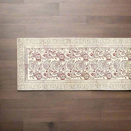 Red and white Vine Block Print Table Runner on a dark wooden surface