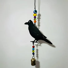 Black metal crow wind chime with colorful beaded strands and a genuine nana bell made from recycled metal