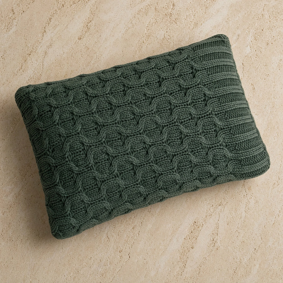 Dark green knitted pillow with textured cable pattern matching curvy green throw washed cotton throw design