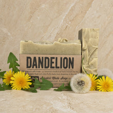 Dandelion palo santo blend bar soap in light green with herbal inclusions and rustic label featuring palo santo essential