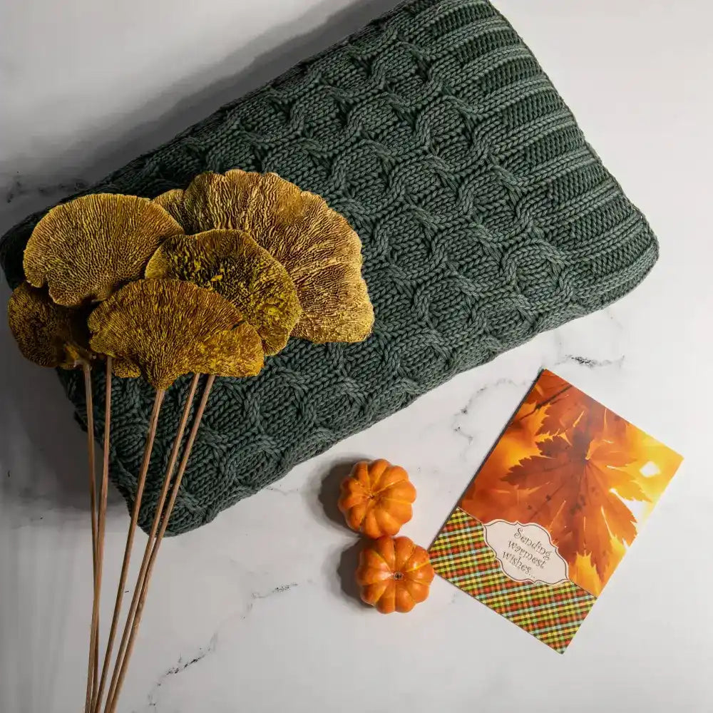 This thick curvy knit throw blanket creates a gorgeous texture with its simple, solid dark green hue.