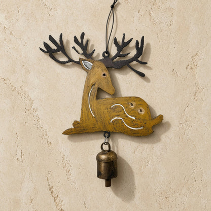A rustic mustard-yellow recycled metal wind deer ornament with black antlers and bronze bell door hanger
