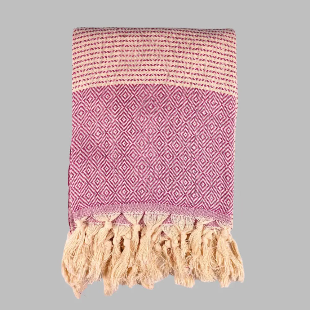Turkish beach towel with diamond and dot woven design.