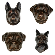 Four bronze dog figurines on a white background