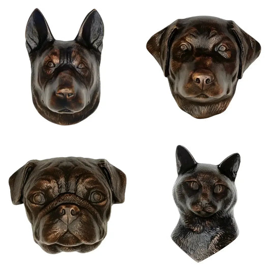 Four bronze dog figurines on a white background