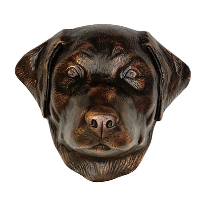 Bronze sculpture of a dog's head on a white background