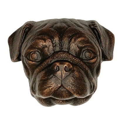 Bronze sculpture of a pug dog head on a white background